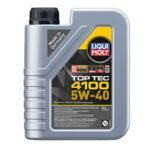 Container of Top Tec 4100 5W-40 synthetic motor oil placed beside a car engine, highlighting premium quality and performance.